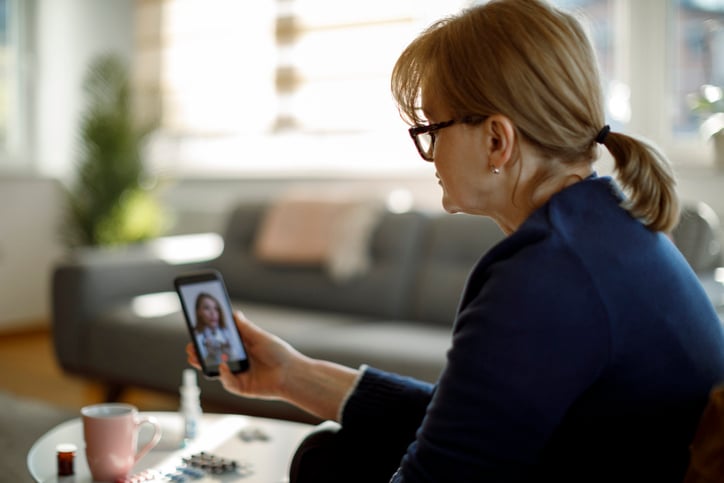 Senior woman consulting with her doctor online stock photo