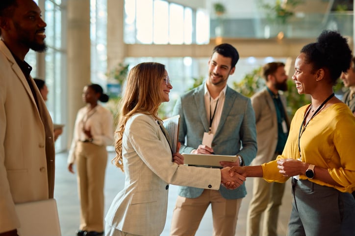businesswomen shaking hands - meet first stop health 