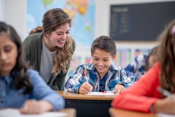 teacher with student in classroom 
