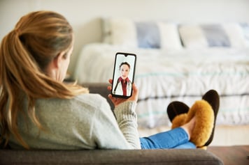 Woman talking into cell phone on telemedicine video call