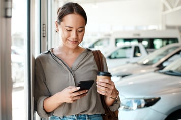 woman smiling at phone