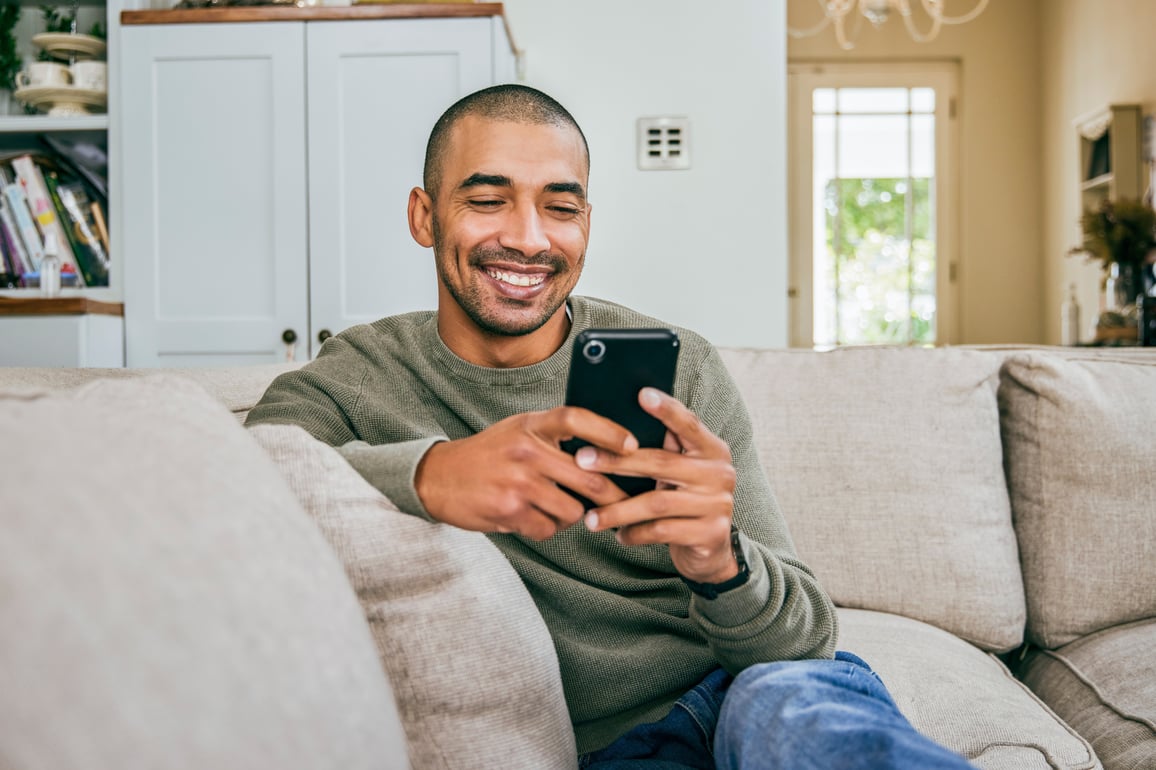 man smiling at phone