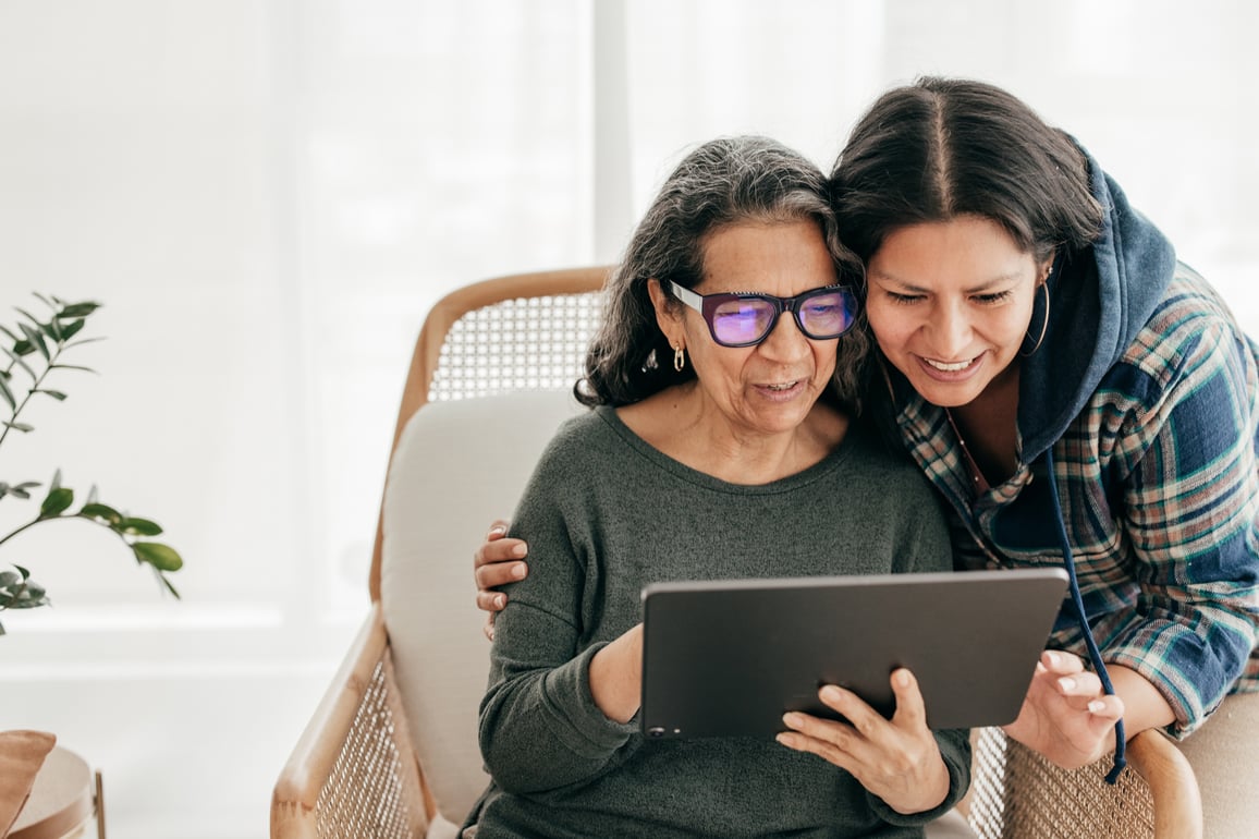 Mother and daughter looking at tablet together tp schedule a telemedicine appointment