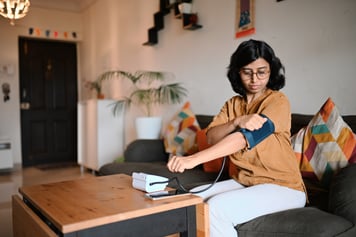 Woman taking blood pressure with virtual doctor