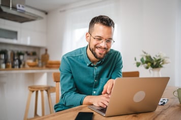 Man smiling at computer