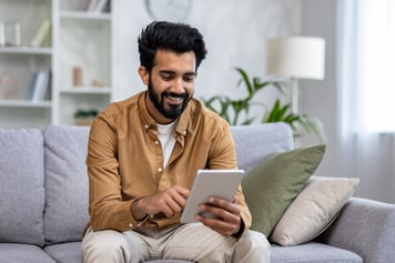 man smiling at tablet