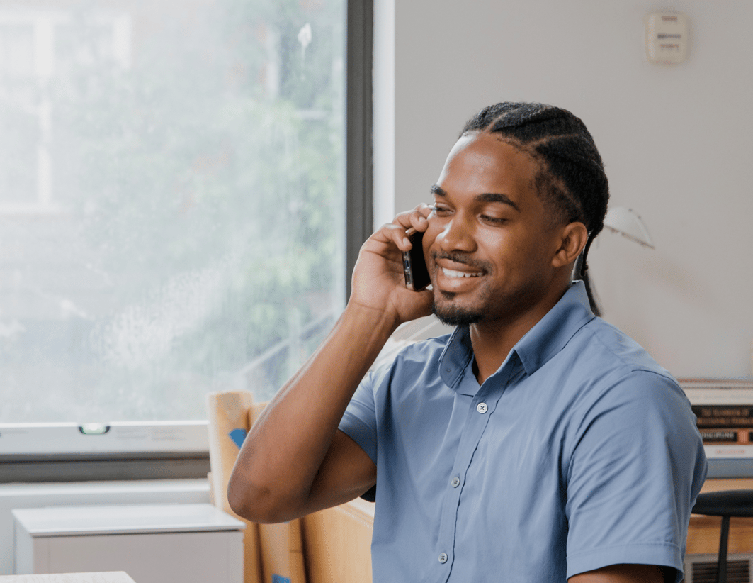 Man smiling on phone doctor's appointment remote